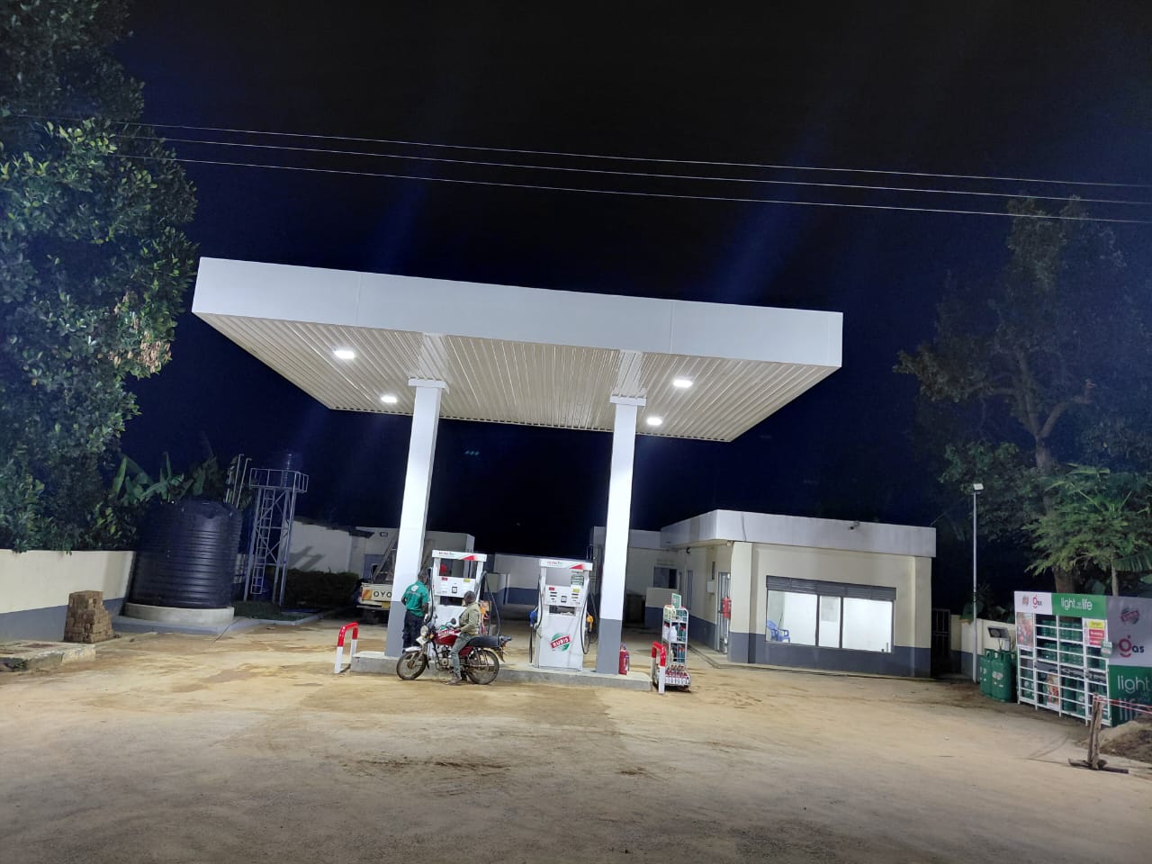 Fuel station with a lit canopy built by Hawkins at night